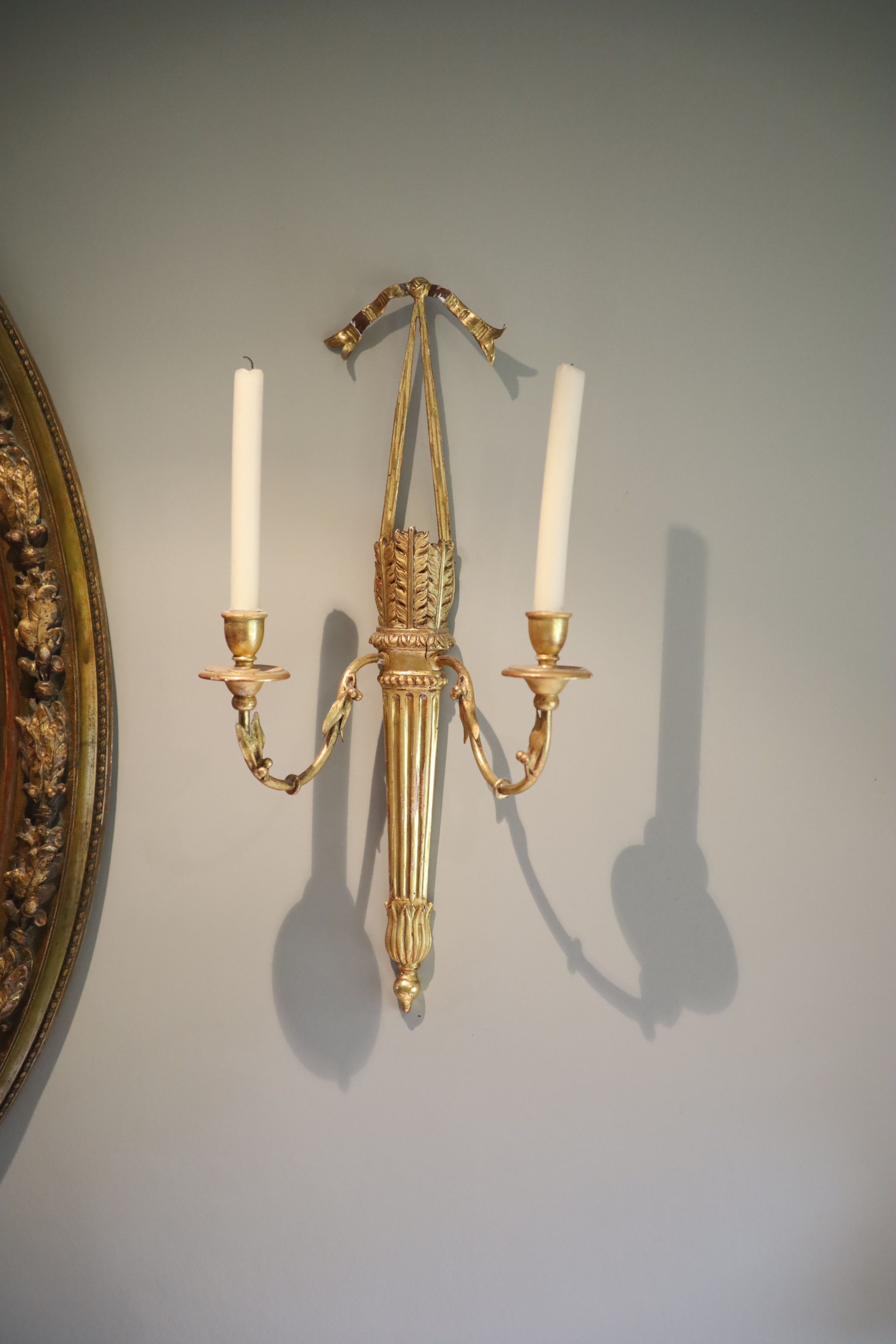 A set of four Georgian style giltwood and gesso twin branch wall lights modelled as quivers, with fruiting branches, height 61cm width 30cm